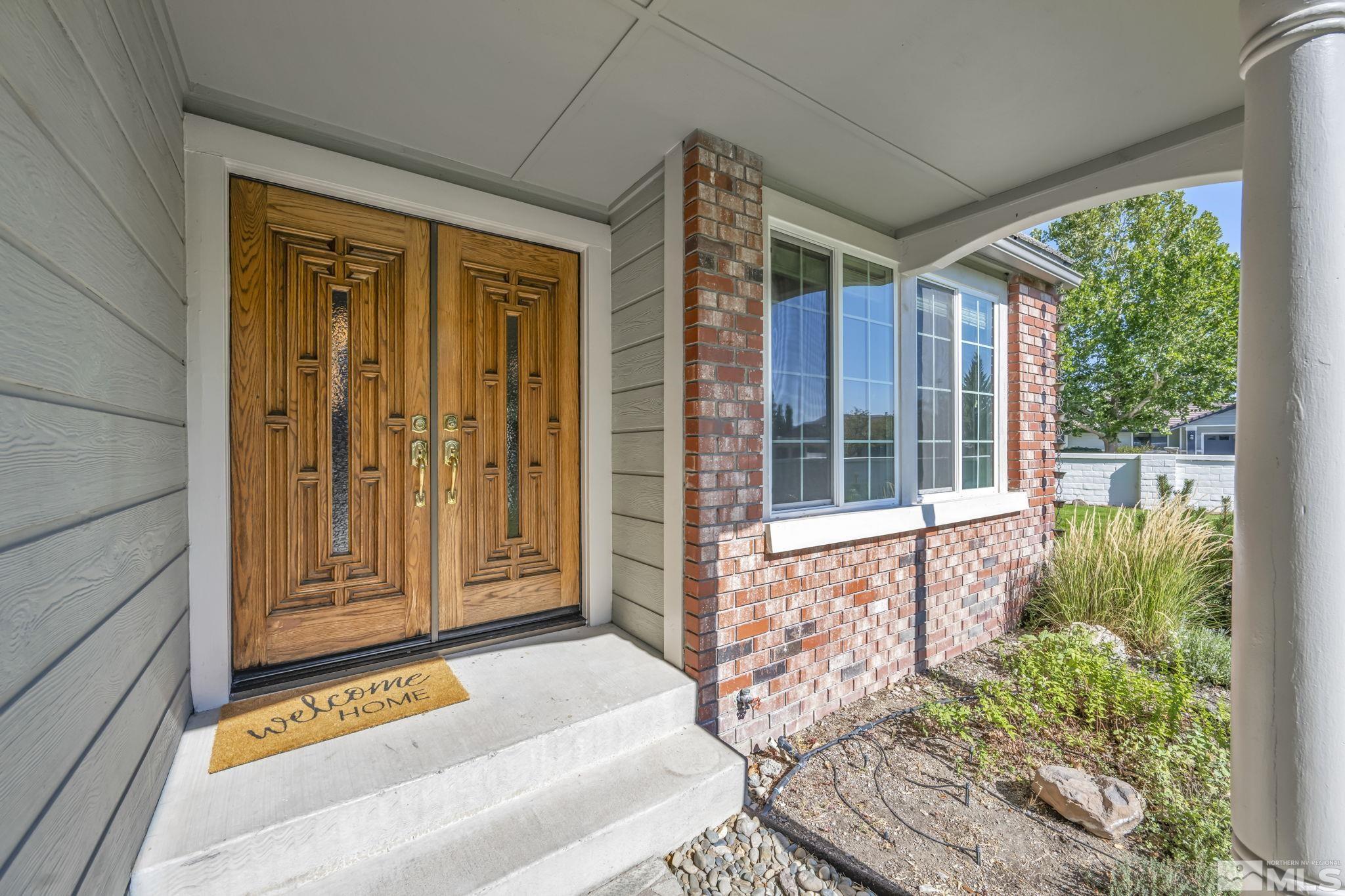 7109 Lighthouse Lane Reno, NV 89511 - Photo 3 of 40 a front door view of a house with a large window