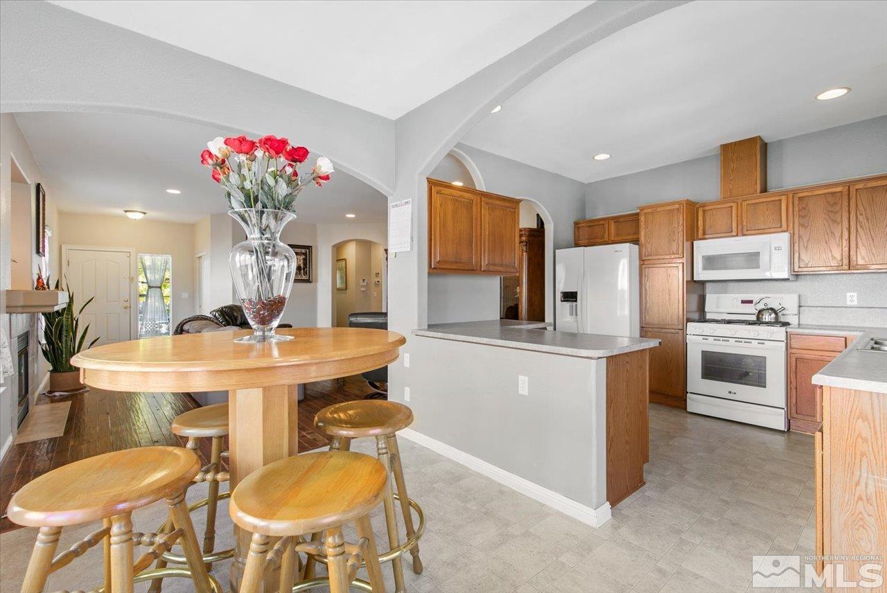 9625 Marble Creek Court Reno, NV 89506 - Photo 12 of 40 a kitchen with sink refrigerator dining table and chairs