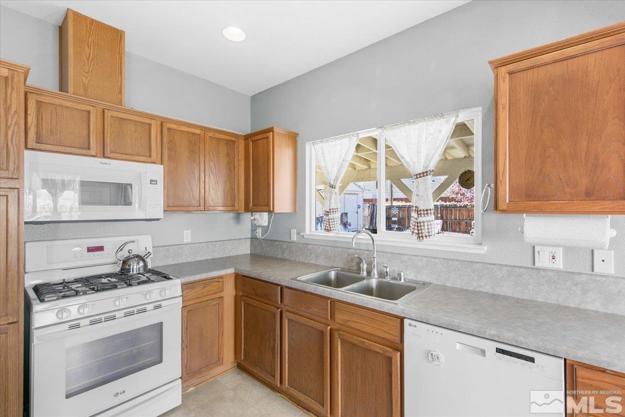 9625 Marble Creek Court Reno, NV 89506 - Photo 16 of 40 a kitchen with a sink stove and cabinets