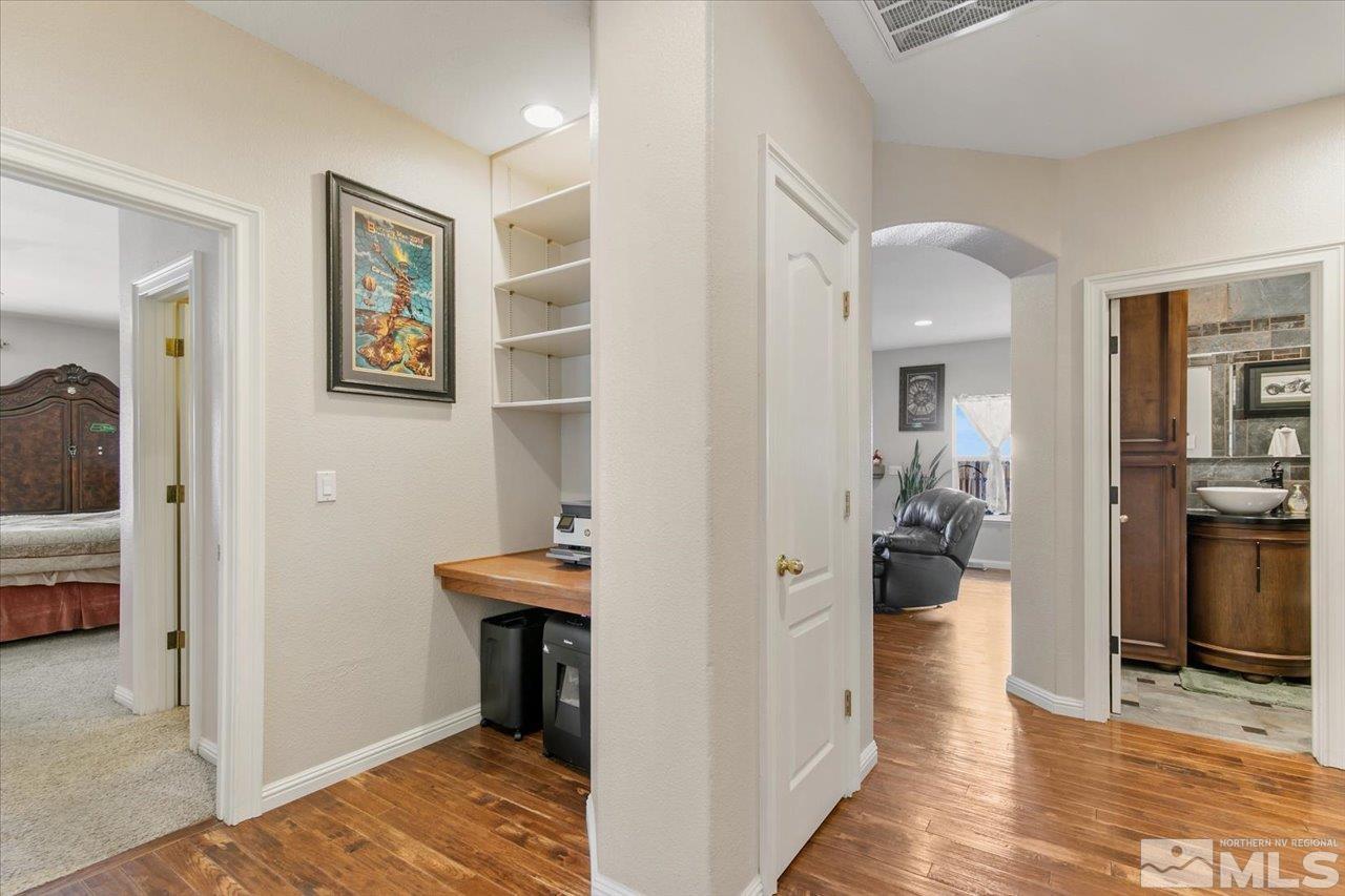 9625 Marble Creek Court Reno, NV 89506 - Photo 17 of 40 a view of a hallway with living room and wooden floor