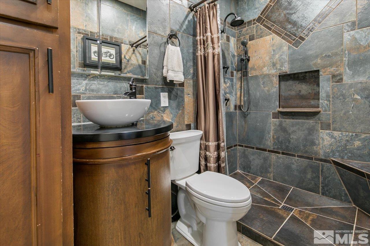 9625 Marble Creek Court Reno, NV 89506 - Photo 18 of 40 a bathroom with a toilet a sink and shower