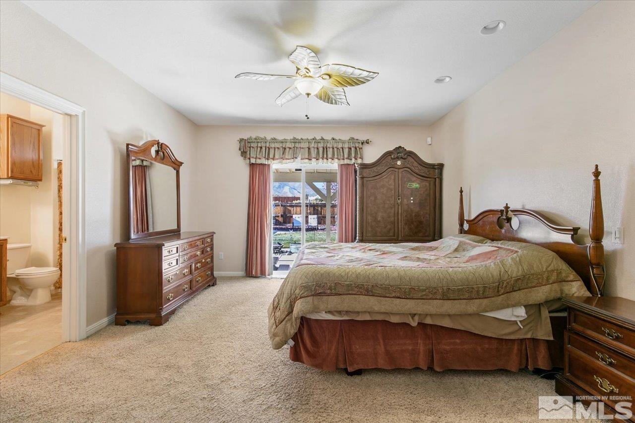 9625 Marble Creek Court Reno, NV 89506 - Photo 19 of 40 a bedroom with a bed closet and a flat tv screen