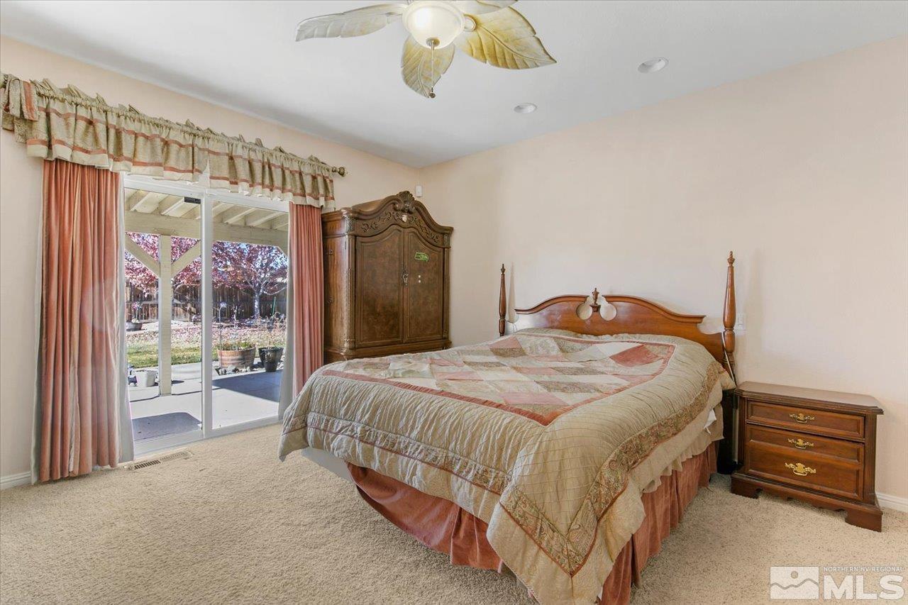 9625 Marble Creek Court Reno, NV 89506 - Photo 20 of 40 a bedroom with a bed wooden floor and window