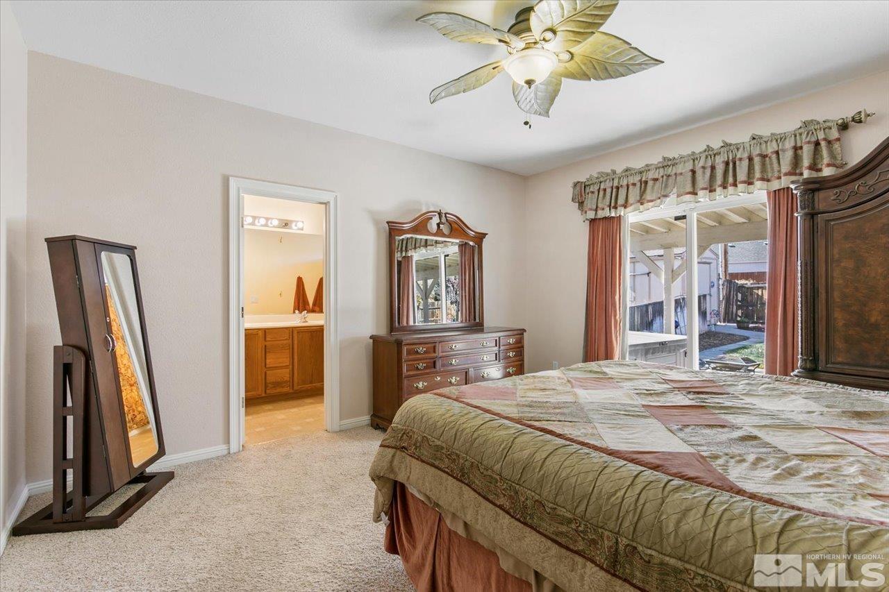 9625 Marble Creek Court Reno, NV 89506 - Photo 21 of 40 a bedroom with a bed and a chandelier