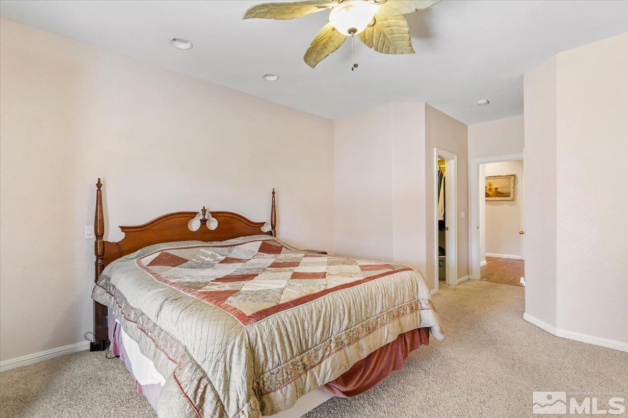 9625 Marble Creek Court Reno, NV 89506 - Photo 23 of 40 a bedroom with a bed and chandelier