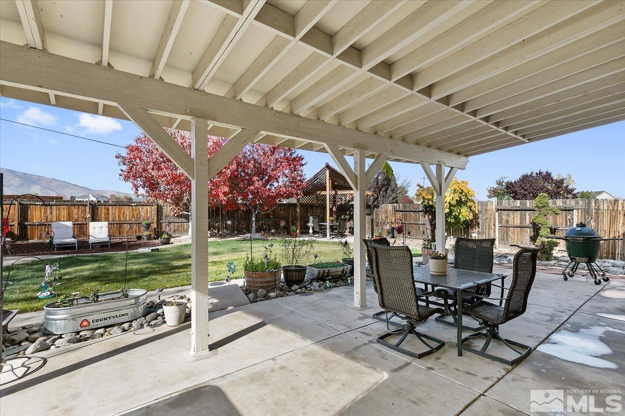 9625 Marble Creek Court Reno, NV 89506 - Photo 29 of 40 a view of a patio with table and chairs potted plants and a large tree