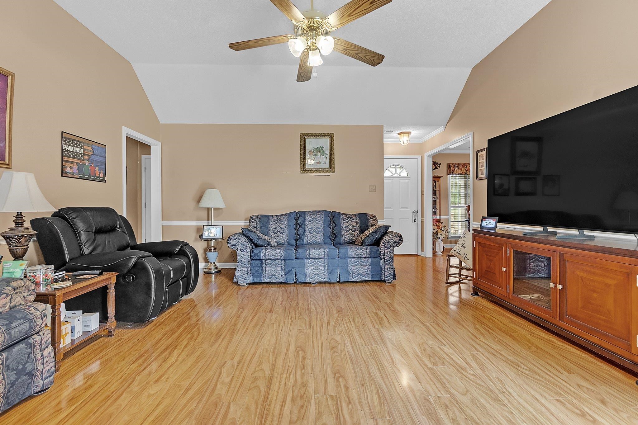 4020 Altruria Road Bartlett, TN 38135 - Photo 6 of 25 Spacious living area featuring vaulted ceilings, wood-finish flooring, and a ceiling fan with integrated lighting