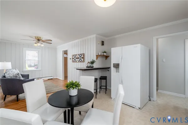 a kitchen with refrigerator and dining table