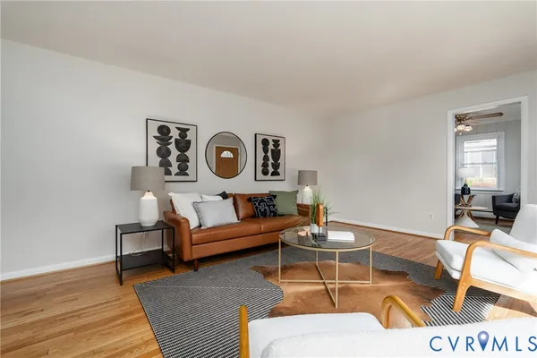 a living room with furniture and wall paintings