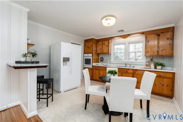 a dining room with furniture and a large window