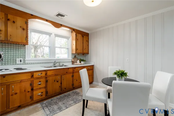 a white kitchen with sink and window