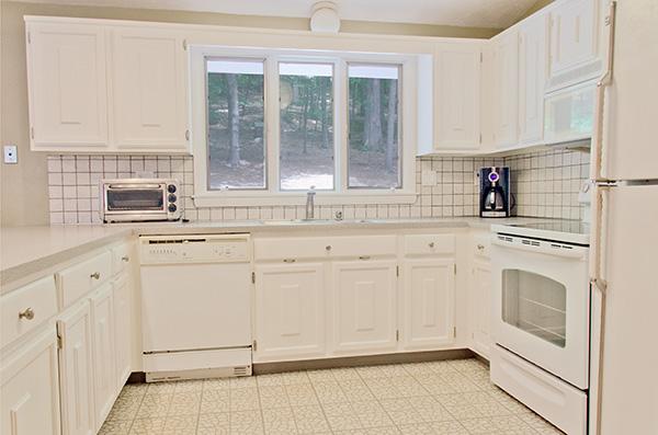 587 Edmands Road Framingham, MA 01701 - Photo 8 of 30 a kitchen with granite countertop white cabinets and white appliances
