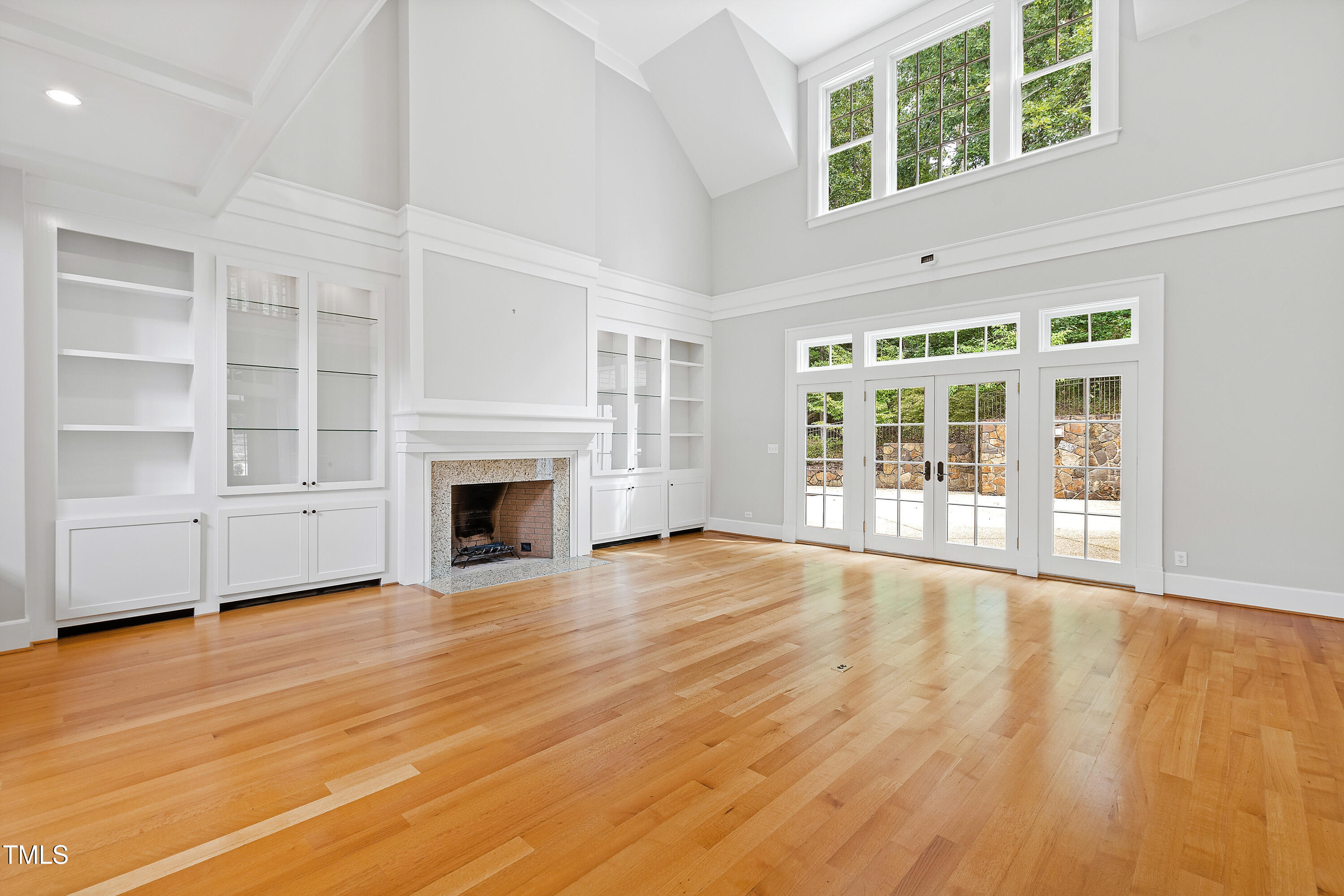 621 Sugarberry Road Chapel Hill, NC 27514 - Photo 11 of 85 an empty room with wooden floor and fireplace