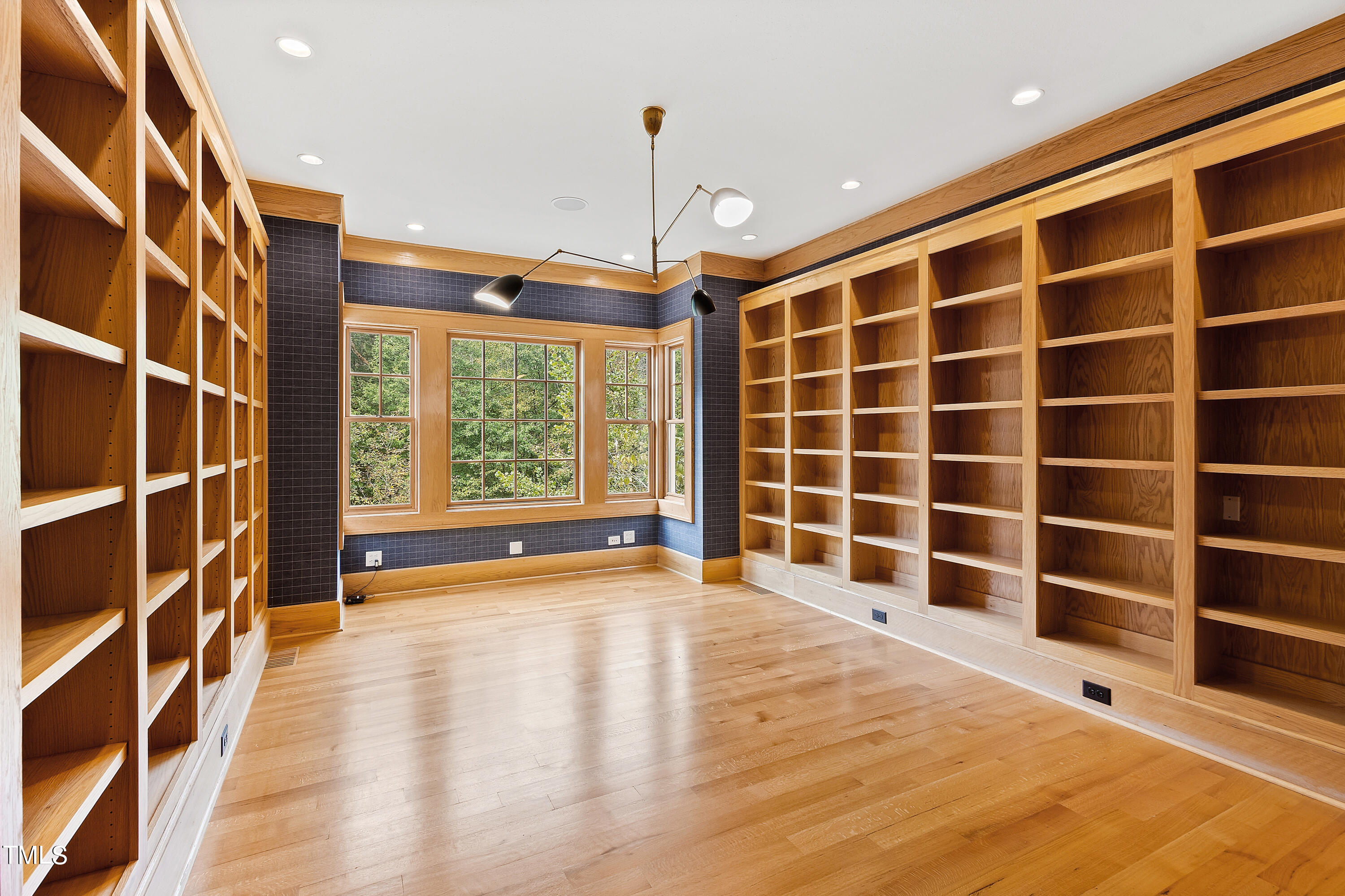 621 Sugarberry Road Chapel Hill, NC 27514 - Photo 27 of 85 a view of an empty room with a window and wooden floor
