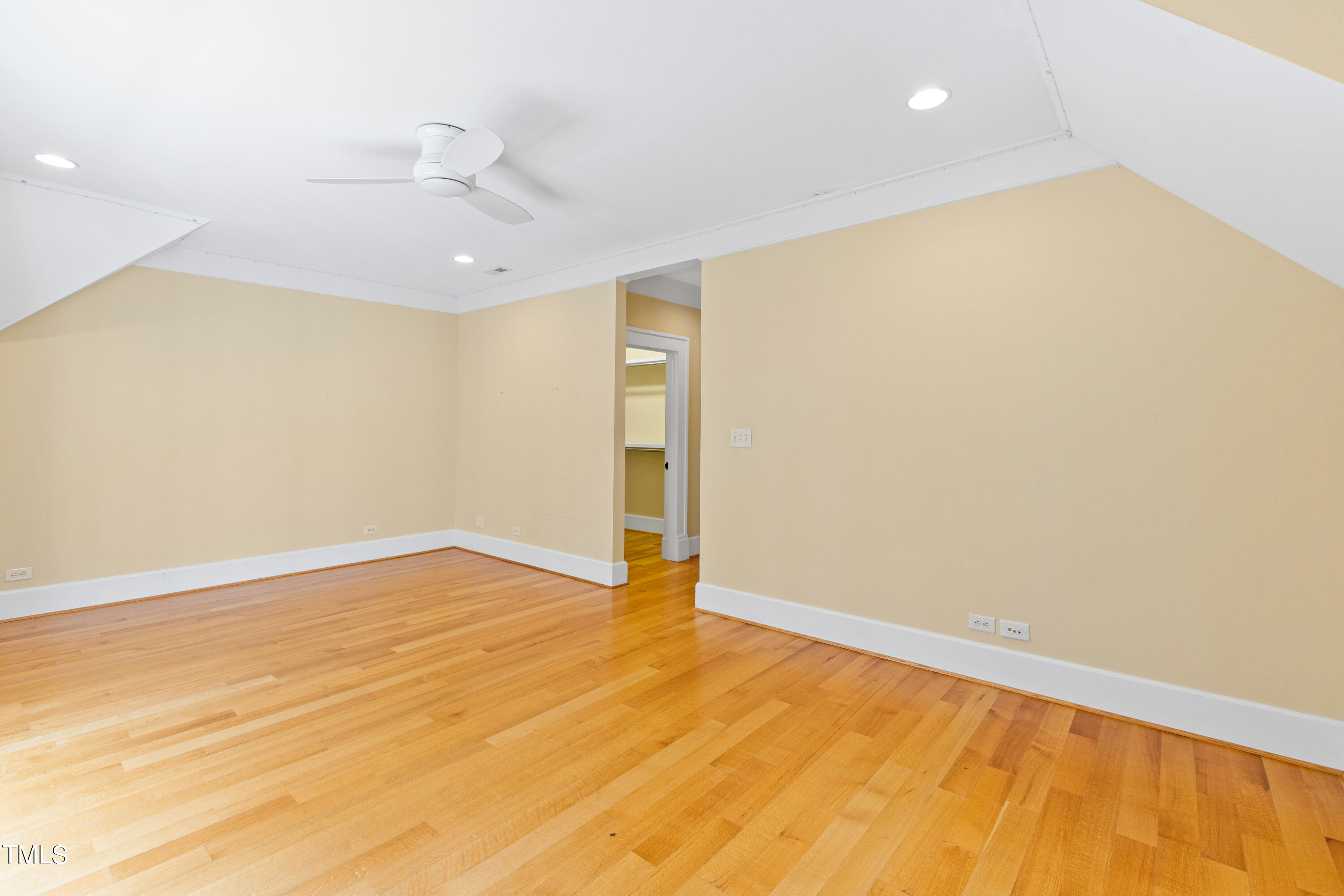 621 Sugarberry Road Chapel Hill, NC 27514 - Photo 46 of 85 an empty room with wooden floor and ceiling fan