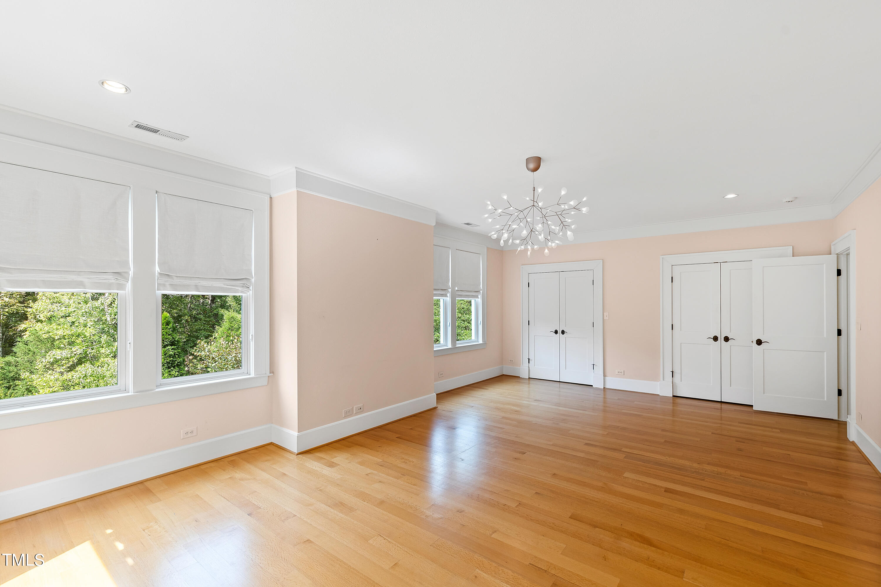 621 Sugarberry Road Chapel Hill, NC 27514 - Photo 52 of 85 a view of an empty room with wooden floor and a window