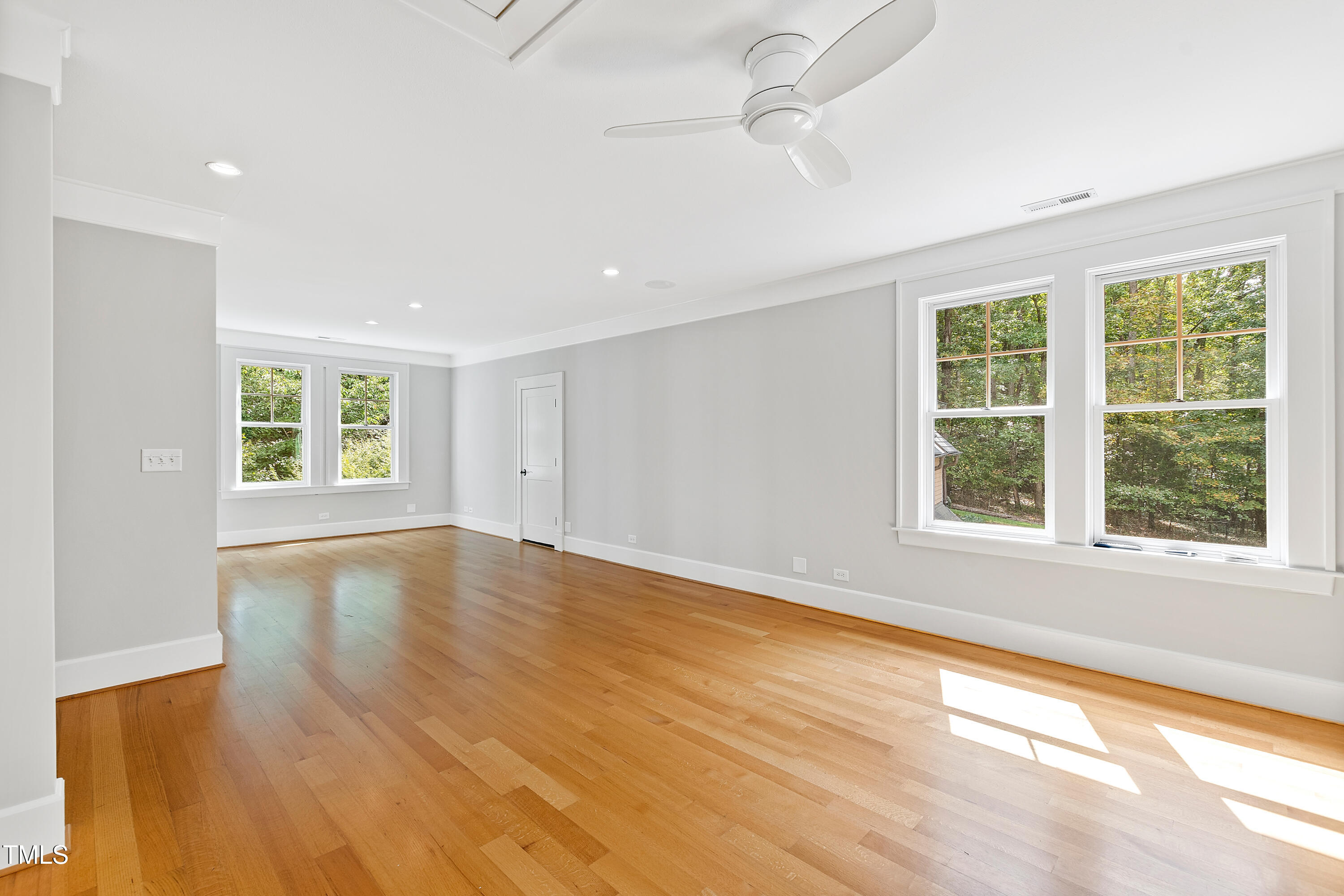 621 Sugarberry Road Chapel Hill, NC 27514 - Photo 56 of 85 a view of an empty room with wooden floor and a window