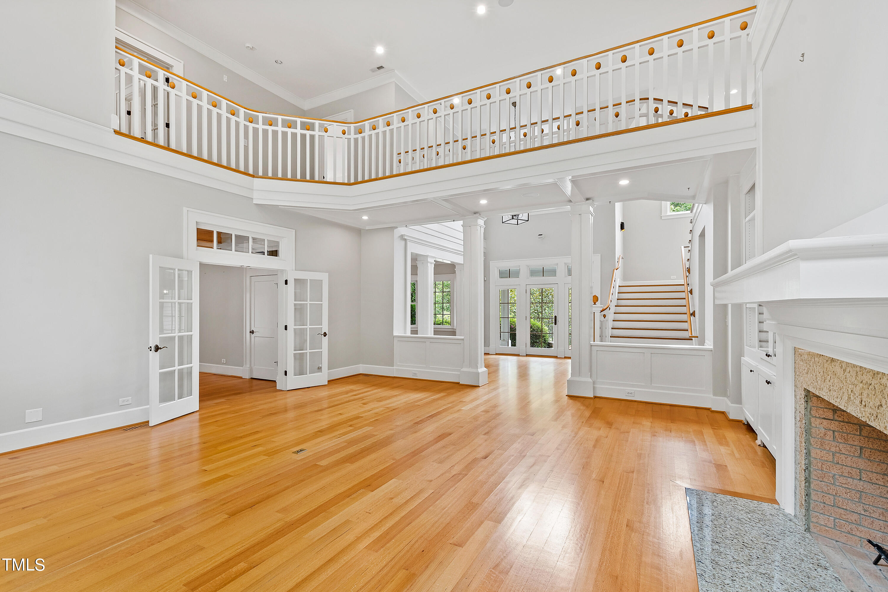 621 Sugarberry Road Chapel Hill, NC 27514 - Photo 10 of 85 a view of a hallway with wooden floor windows and a fireplace