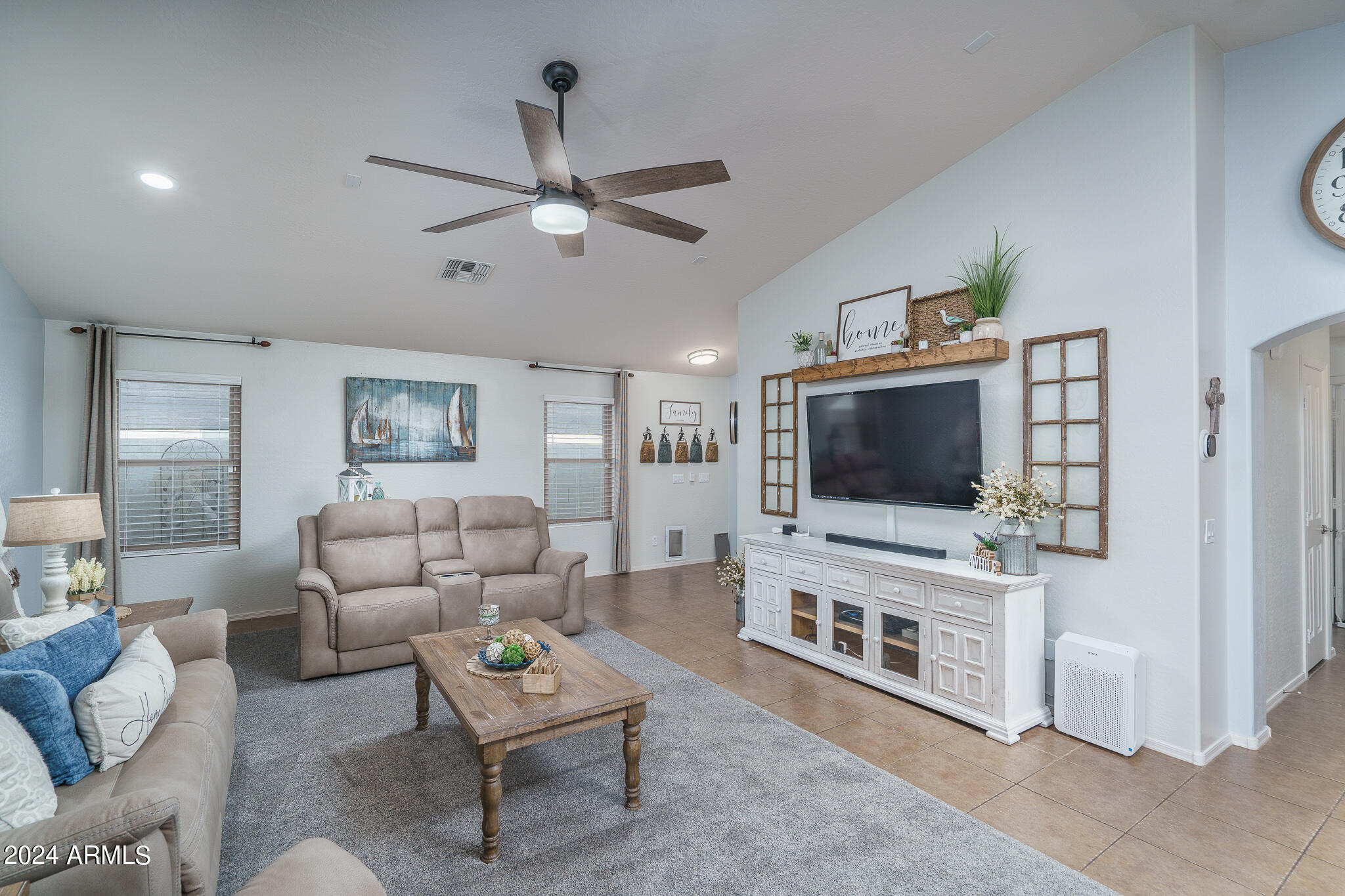 17732 West Calavar Road Surprise, AZ 85388 - Photo 4 of 40 a living room with furniture and a flat screen tv