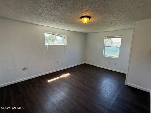 402 Rivard Road South Moxee, WA 98936 - Photo 5 of 9 an empty room with wooden floor and windows
