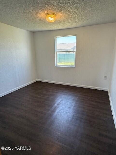 402 Rivard Road South Moxee, WA 98936 - Photo 6 of 9 an empty room with wooden floor and windows