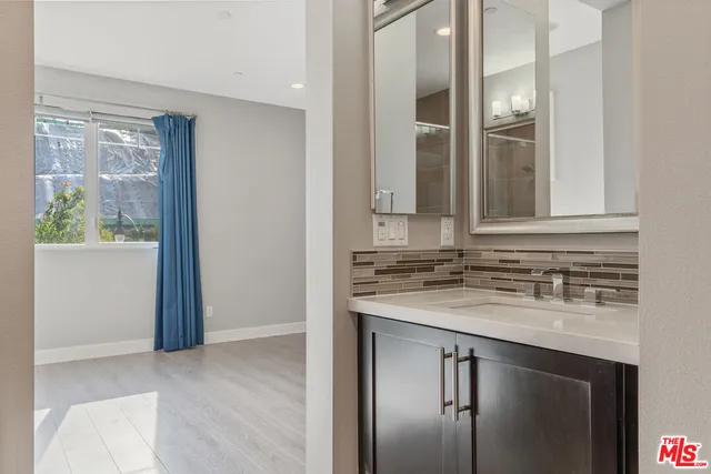 a view of a pathway both side of house