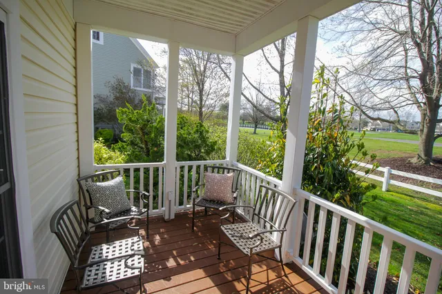a view of a dining room with furniture a kitchen and chandelier