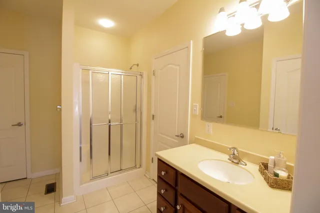 a living room with furniture kitchen view and a large window