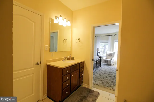 a bathroom with a sink a toilet and mirror