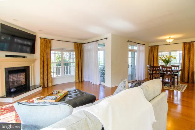 a spacious bedroom with a bed and glass window