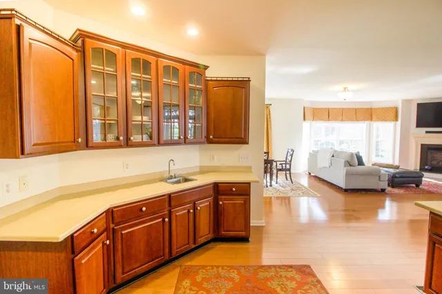 a bedroom with a bed couch and wooden floor