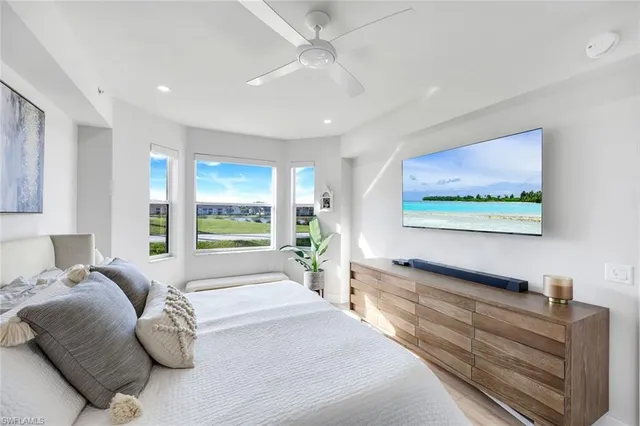 a spacious bedroom with a large bed and a large window