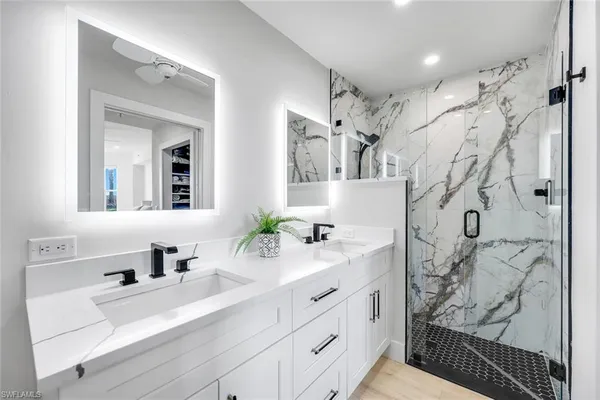 a bathroom with double vanity sink and a mirror