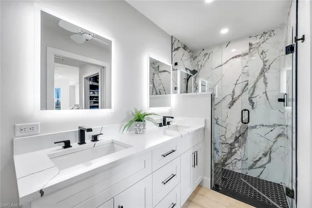 a bathroom with double vanity sink and a mirror