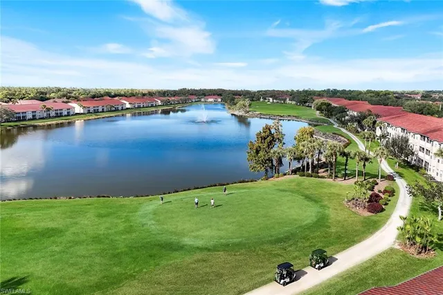 an aerial view of a houses with a lake view