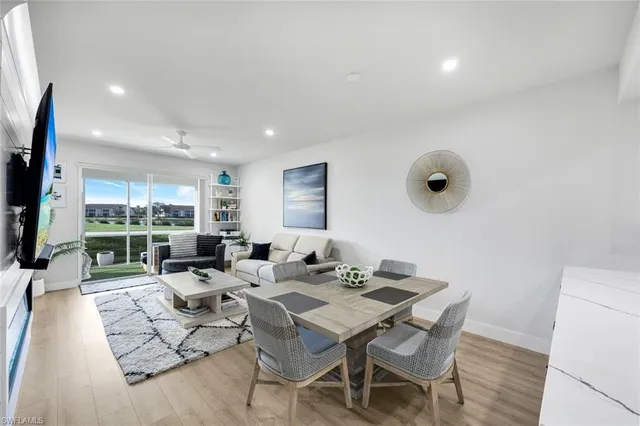 a living room with patio furniture and a flat screen tv