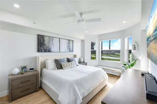 a bedroom with a large bed and a large window