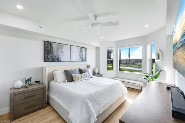 a bedroom with a large bed and a large window