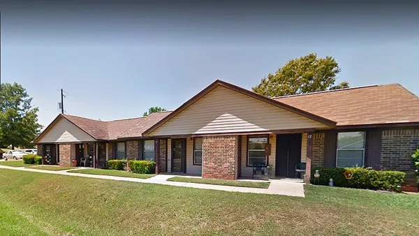 a front view of a house with a yard and porch