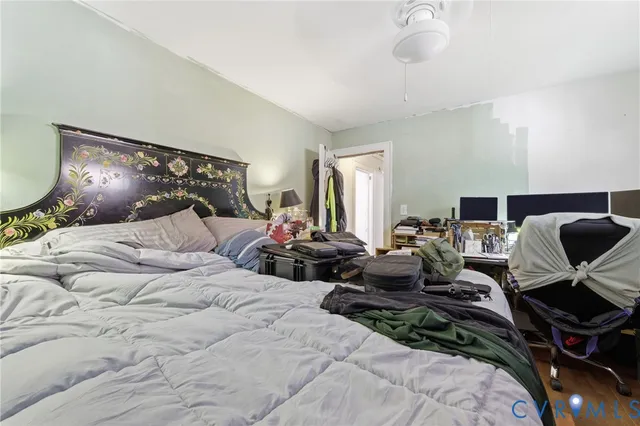 a bedroom with a bed and large mirror