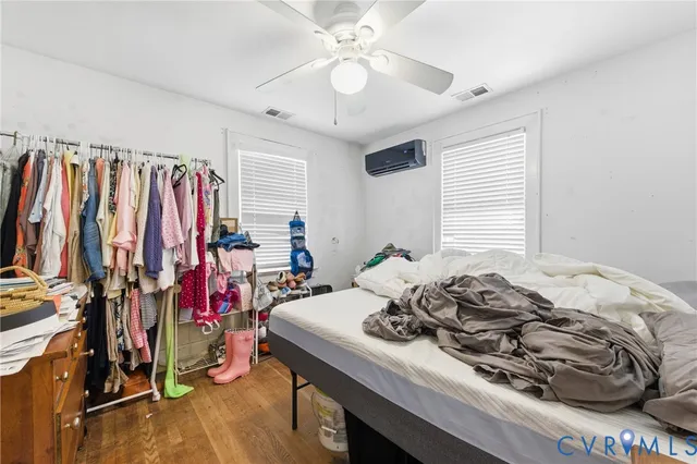 a view of a bedroom with a bed and a window