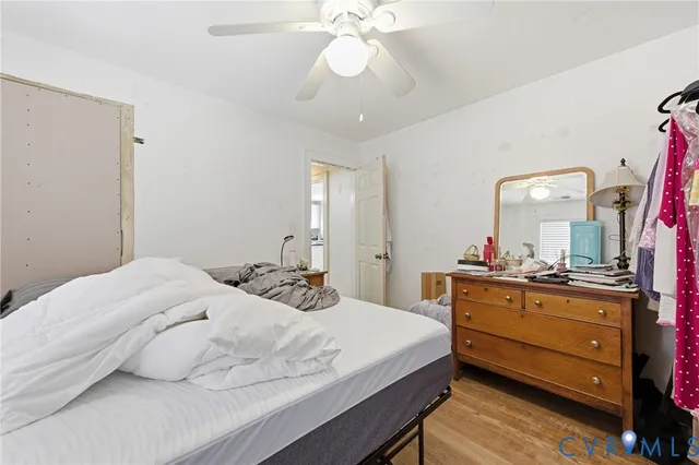 a bedroom with a bed and a mirror on dresser