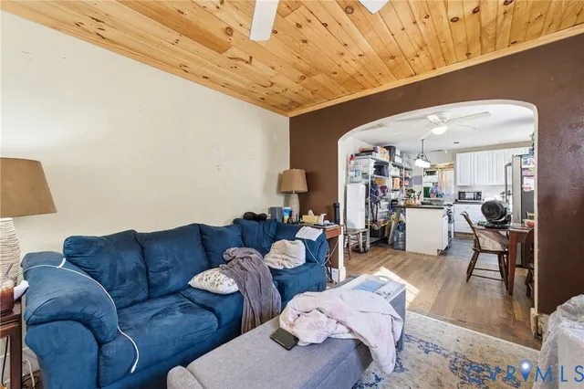 a living room with furniture and wooden floor