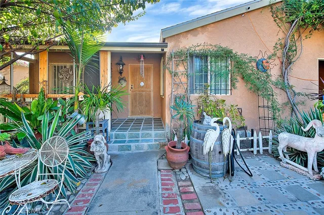 a view of a porch with chairs and potted plants