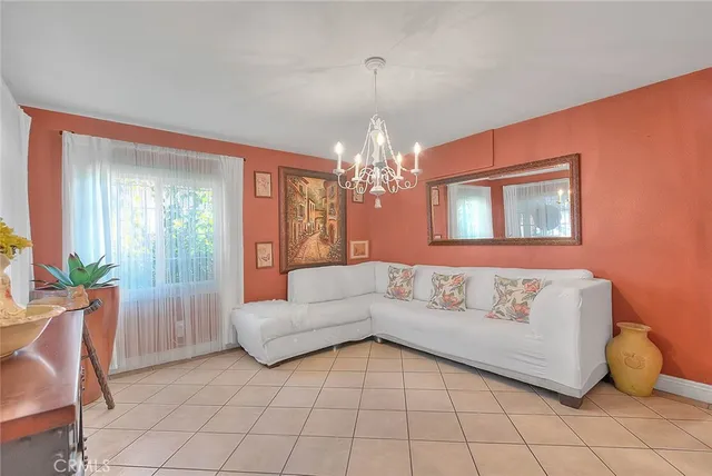 a kitchen with stainless steel appliances granite countertop a stove top oven a sink a dining table and chairs