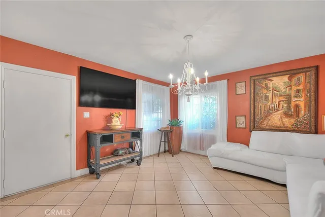 a kitchen with granite countertop a refrigerator stove top oven dining table and chairs