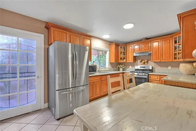 an empty room with wooden floor closet and windows