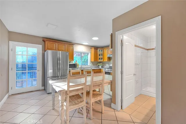 a bedroom with a bed mirror and window