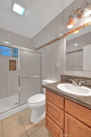 a bedroom with a bed and a dresser in it