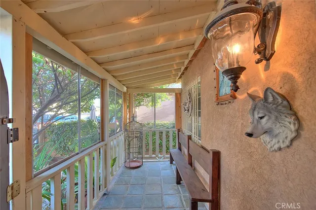 a living room with furniture a flat screen tv and a chandelier